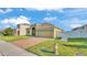 Charming home with well-kept lawn, a brick driveway, and easy access to city utilities at 428 Aragosa Dr, Davenport, FL 33837