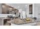 Well-lit kitchen with stainless steel appliances and granite countertops provides a modern feel at 428 Aragosa Dr, Davenport, FL 33837