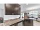 Granite countertop and stainless dishwasher with dark cabinets create a luxurious space at 428 Aragosa Dr, Davenport, FL 33837