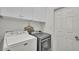 Bright laundry room equipped with modern, front-loading washer and dryer units at 428 Aragosa Dr, Davenport, FL 33837