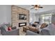 Inviting living room with fireplace, stone wall, and ample natural light from sliding glass doors at 428 Aragosa Dr, Davenport, FL 33837