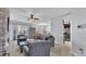 Cozy living room with tiled floors, ceiling fan, and stone fireplace with mounted television at 428 Aragosa Dr, Davenport, FL 33837