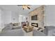 Spacious living room with stone fireplace, tv, and seamlessly connected to dining and kitchen areas at 428 Aragosa Dr, Davenport, FL 33837