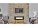 Living room showcasing stone wall fireplace, flat screen tv, and cozy seating area at 428 Aragosa Dr, Davenport, FL 33837