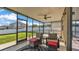 Enjoy the outdoors in this screened patio with comfortable seating, a ceiling fan, and a view of the backyard at 428 Aragosa Dr, Davenport, FL 33837