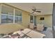 Enjoy the outdoors in this screened patio with comfortable seating, a ceiling fan, and a view of the backyard at 428 Aragosa Dr, Davenport, FL 33837