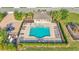 Top-down aerial shot of the community pool area with a pavilion, lounge chairs, and lush landscaping at 428 Aragosa Dr, Davenport, FL 33837