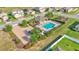 Aerial view of community pool with lounge area, a covered pavilion, and ample parking at 428 Aragosa Dr, Davenport, FL 33837