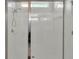 Bright, modern bathroom shower with clear glass doors and white tiled walls at 428 Aragosa Dr, Davenport, FL 33837
