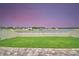 This spacious yard provides a scenic water view and a beautiful stone paver patio area at 4400 Trotters Way, Lakeland, FL 33801