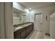 Bathroom with double sinks, granite countertops, and tile floors at 4400 Trotters Way, Lakeland, FL 33801