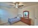 Cozy bedroom with a ceiling fan, a full dresser with mirror, and a single bed at 4400 Trotters Way, Lakeland, FL 33801