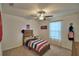 Bedroom with a wooden bed frame, ceiling fan and a window with natural light at 4400 Trotters Way, Lakeland, FL 33801