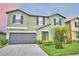 Charming two-story home with a well-maintained lawn and a two-car garage at 4400 Trotters Way, Lakeland, FL 33801