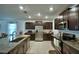 Well-lit kitchen with stainless steel appliances, dark wood cabinets, and granite countertops, offering a sleek design at 4400 Trotters Way, Lakeland, FL 33801