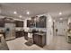 Spacious kitchen with stainless steel appliances, dark wood cabinets, and a modern design at 4400 Trotters Way, Lakeland, FL 33801