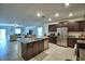 Modern kitchen featuring stainless steel appliances, granite countertops, and open to the living area at 4400 Trotters Way, Lakeland, FL 33801