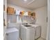 A laundry room featuring a washing machine and dryer, and a shelf at 4400 Trotters Way, Lakeland, FL 33801
