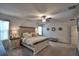 This main bedroom boasts carpet, a ceiling fan, and a window with blinds at 4400 Trotters Way, Lakeland, FL 33801