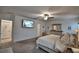 This main bedroom features a TV and a ceiling fan with light at 4400 Trotters Way, Lakeland, FL 33801