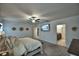 This main bedroom features carpet, a ceiling fan, a wall-mounted TV, and ensuite bath access at 4400 Trotters Way, Lakeland, FL 33801