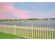 Scenic water view with a white picket fence and neighboring homes at the Saddle Creek Preserve at 4400 Trotters Way, Lakeland, FL 33801