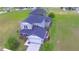 Aerial view of a 2-story home featuring a 2-car garage and green lawn at 445 Waterfern Trail Dr, Auburndale, FL 33823
