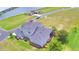 Aerial view of 2-story home featuring mature trees, a screened in porch and well-manicured shrubs at 445 Waterfern Trail Dr, Auburndale, FL 33823