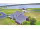 Aerial view of 2-story home on an expansive lot with water views and surrounding landscaping at 445 Waterfern Trail Dr, Auburndale, FL 33823