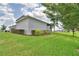 Spacious backyard with well-maintained landscaping, including shrubs and green grass, for outdoor enjoyment at 445 Waterfern Trail Dr, Auburndale, FL 33823