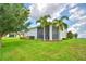 Lush backyard with healthy lawn, landscaping, and a screened porch perfect for enjoying the outdoors at 445 Waterfern Trail Dr, Auburndale, FL 33823