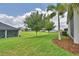 Expansive backyard featuring a lush green lawn, mature trees, and well-maintained landscaping at 445 Waterfern Trail Dr, Auburndale, FL 33823