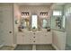 Bathroom featuring double sinks, modern lighting, and a glass-enclosed shower at 445 Waterfern Trail Dr, Auburndale, FL 33823