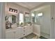 Bathroom featuring double sinks, modern lighting, and a glass-enclosed shower at 445 Waterfern Trail Dr, Auburndale, FL 33823