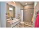 This bathroom is equipped with tile floors, shower, and a framed mirror at 445 Waterfern Trail Dr, Auburndale, FL 33823