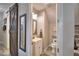 Compact powder room with a sliding barn door, vanity sink, and toilet; space-efficient and tastefully designed at 445 Waterfern Trail Dr, Auburndale, FL 33823