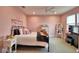 Spacious bedroom features pink walls, carpet flooring, a ceiling fan, and comfortable furnishings at 445 Waterfern Trail Dr, Auburndale, FL 33823