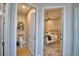 View of bedroom with wood floors, ceiling fan, and stylish décor from hallway at 445 Waterfern Trail Dr, Auburndale, FL 33823