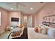 Bedroom featuring pink walls, carpet flooring, a ceiling fan, and comfortable furnishings at 445 Waterfern Trail Dr, Auburndale, FL 33823