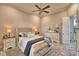 Beautiful bedroom boasts wood floors, a ceiling fan, and stylish décor at 445 Waterfern Trail Dr, Auburndale, FL 33823