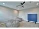 Spacious bonus room features plush carpeting, a ceiling fan, and potential for versatile use at 445 Waterfern Trail Dr, Auburndale, FL 33823