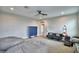 This bonus room features plush carpeting, a ceiling fan, and comfortable seating at 445 Waterfern Trail Dr, Auburndale, FL 33823