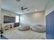 Spacious bonus room features two bean bags, a TV, and ceiling fan at 445 Waterfern Trail Dr, Auburndale, FL 33823