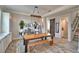 Comfortable dining area with a rustic wood table, bench, and decorative accents adjoining staircase at 445 Waterfern Trail Dr, Auburndale, FL 33823