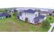 Beautiful two-story home featuring a landscaped yard and screened in porch, set against a picturesque lake backdrop at 445 Waterfern Trail Dr, Auburndale, FL 33823