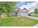 Attractive two-story home with a spacious front yard, showcasing lush green grass and landscaping at 445 Waterfern Trail Dr, Auburndale, FL 33823