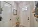 Inviting foyer with neutral walls, white doors, and elegant decor, creating a welcoming first impression at 445 Waterfern Trail Dr, Auburndale, FL 33823