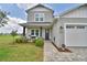 Inviting two-story home boasting a cozy front porch with seating and well-maintained landscaping at 445 Waterfern Trail Dr, Auburndale, FL 33823