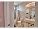 Hallway view into bathroom featuring shower, toilet, and vanity with sink at 445 Waterfern Trail Dr, Auburndale, FL 33823