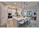 Bright kitchen with white cabinets, stainless appliances, and center island featuring pendant lighting and seating at 445 Waterfern Trail Dr, Auburndale, FL 33823